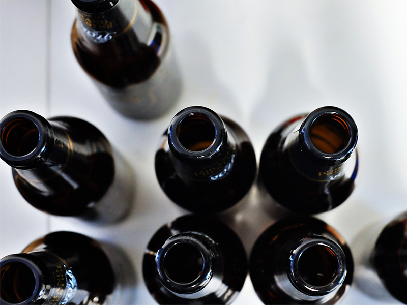 A groupd of empty brown bottles seen from above.